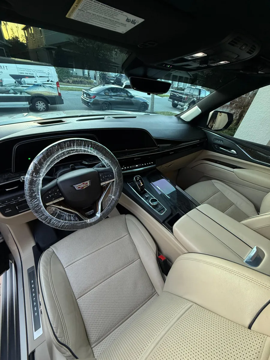 Cleaned Cadillac light leather front seats and dashboard
