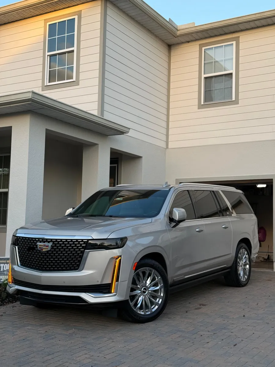 Silver Cadillac SUV parked at a customer's home after mobile detailing