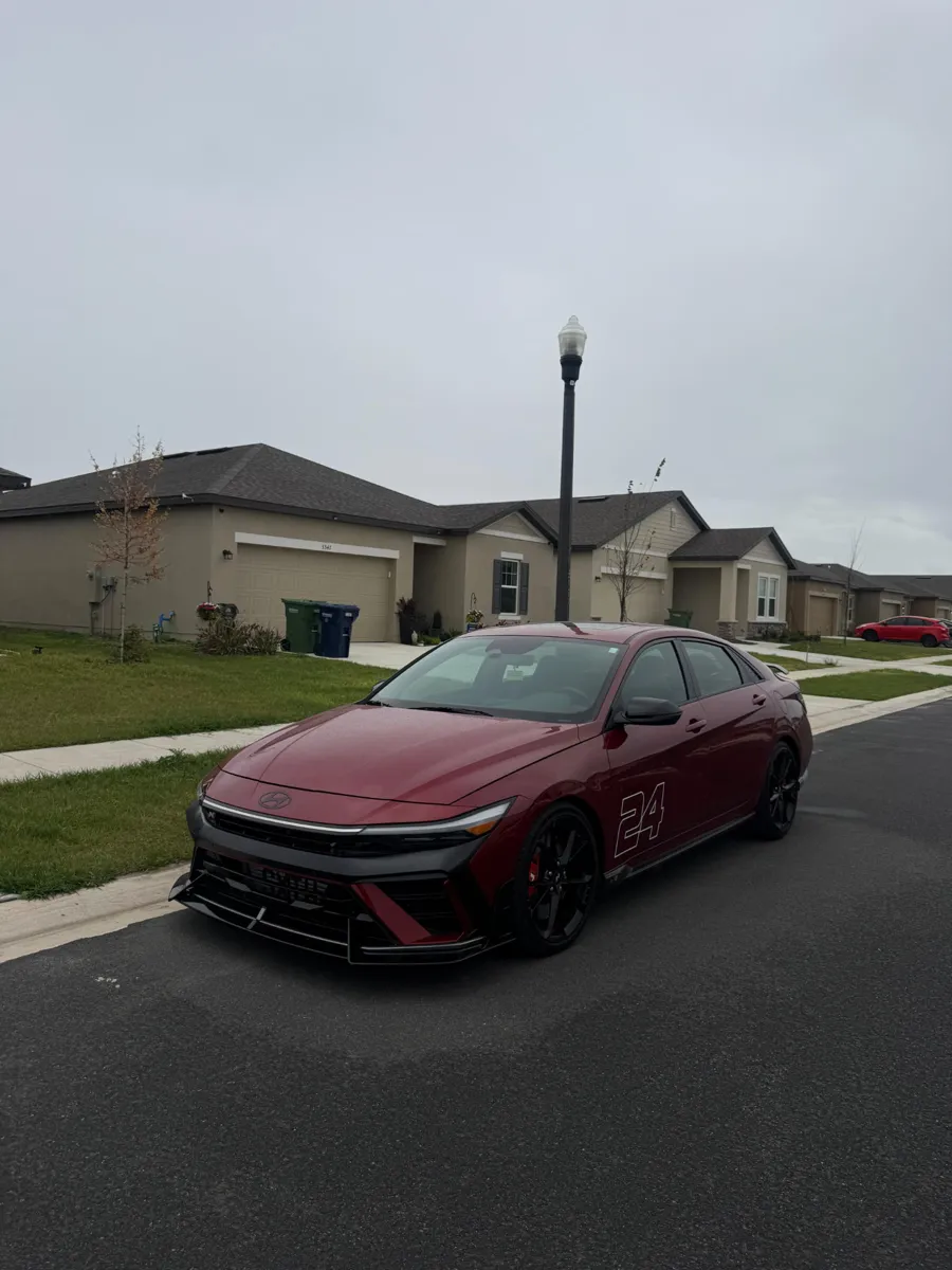 Red Hyundai sedan parked on a residential street after mobile detailing